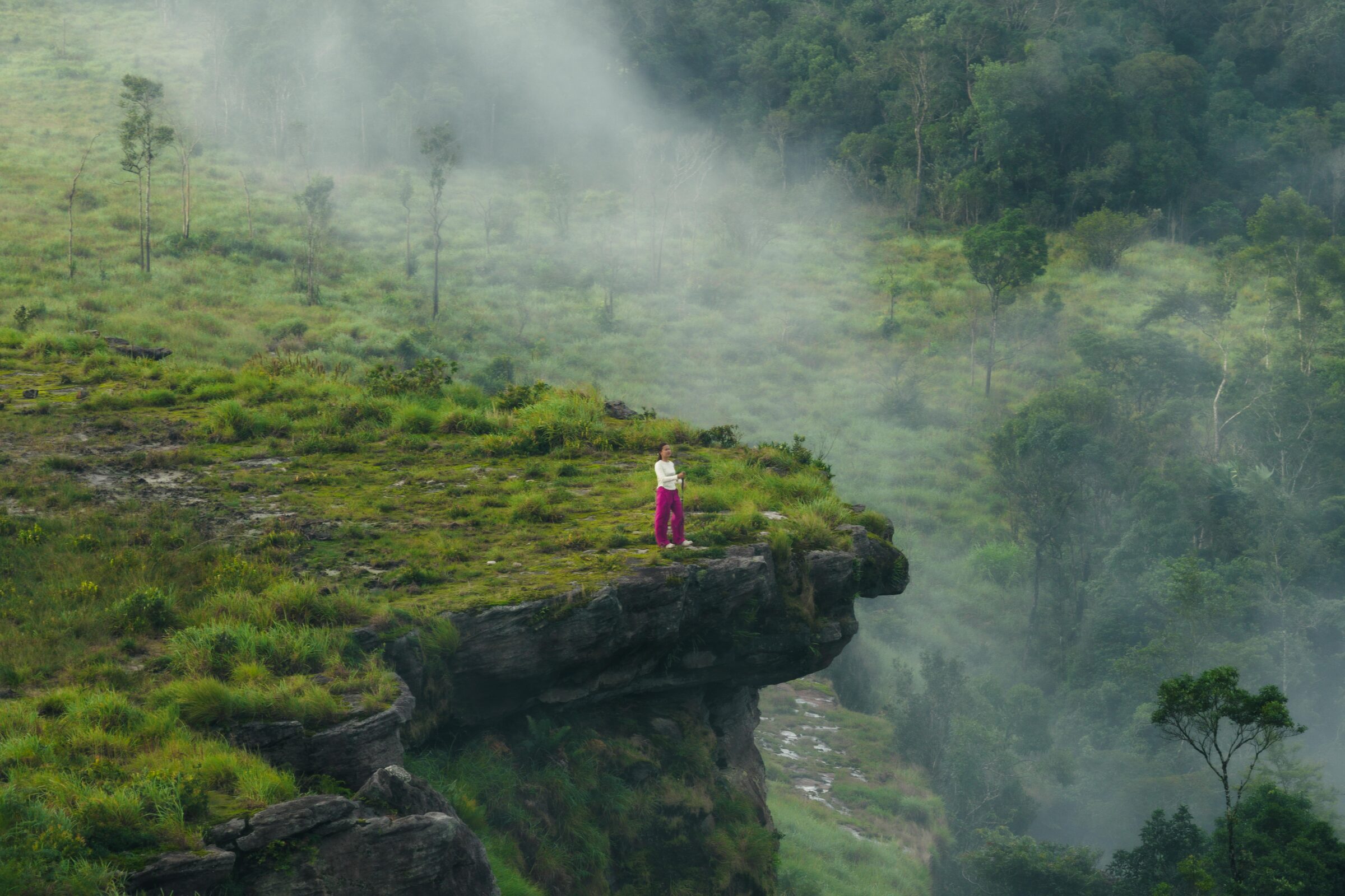 Mist drifts slowly through the valleys below.